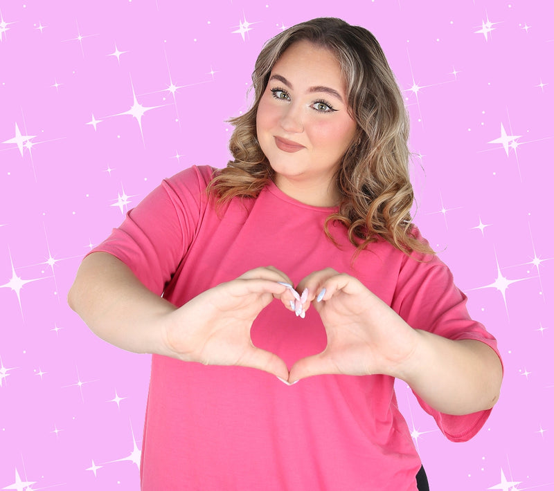 Ruby from Ruby and Bonnie making a heart shape with her hands on pink sparkle background for discount popup